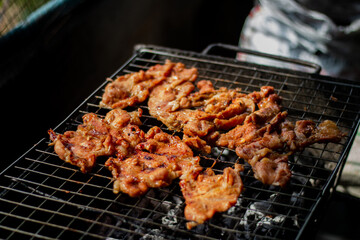 Cooking Grilled Pork Neck in Esan Style (Thai Food).