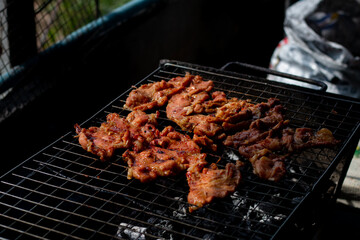 Cooking Grilled Pork Neck in Esan Style (Thai Food).