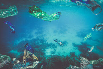 Fototapeta na wymiar plastic waste, bottle bags floating underwater in the sea.