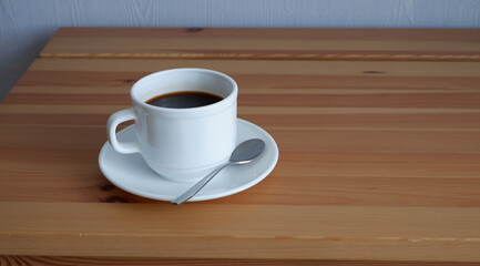 A Cup of coffee on a wooden table. Suitable for background and mockup