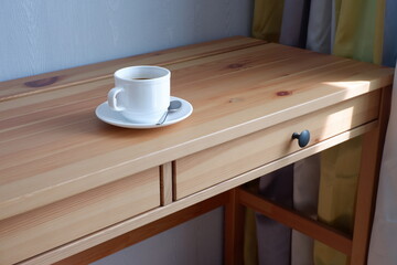 Fototapeta na wymiar A Cup of coffee on a wooden table. Suitable for background and mockup