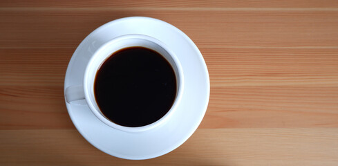 A Cup of coffee on a wooden table. Suitable for background and mockup