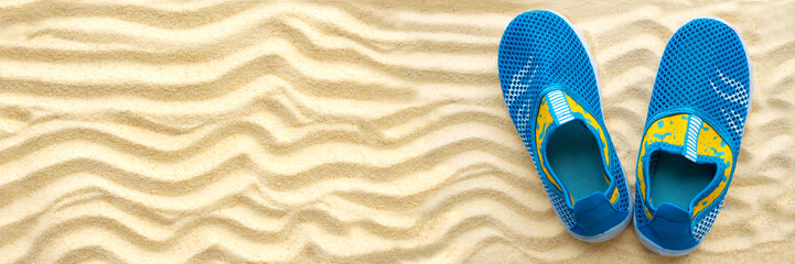Banner3:1. Water shoes on sandy beach. Top view. Copy space