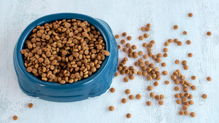 Dry pet food. Food for dogs. Cat food. Fine dry food in a bowl.