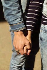 Close up picture of two hands of man and woman holding together