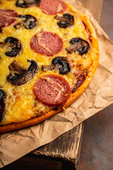 Freshly making pizza with mushrooms served on the rustic background. Selective focus. Shallow depth of field.