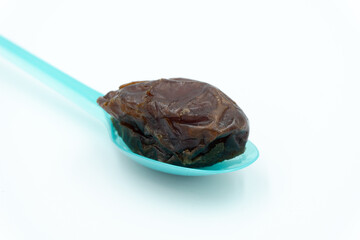 Close up of dates on blue spoon