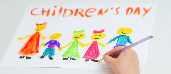 Girl is drawing the colorful children by watercolors with words Happy Children's Day.