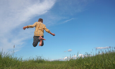Boy jumps with joy vacation happiness nature and freedom