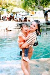 Fototapeta na wymiar happy family having fun on the blue lagoon Vangvieng Lao pdr