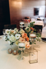 Wedding flowers on the banquet table. Table decoration. Table setting and decorations.