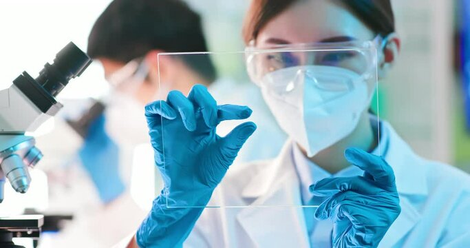 scientist take transparent tablet