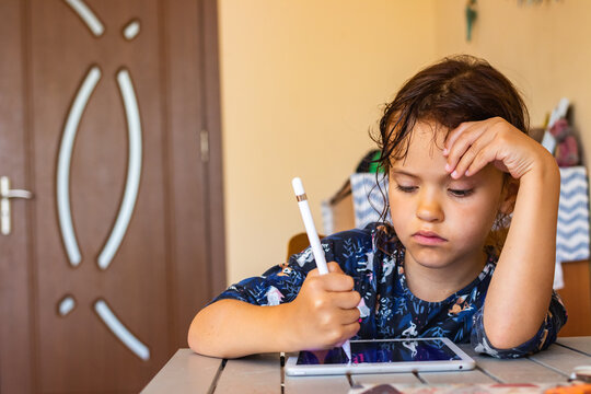 Homeschooling teenager girl study how to draw illustrations and use tablet gadget.