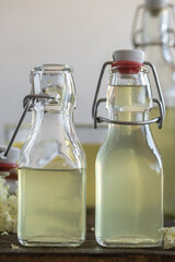 Two bottles of homemade elderflower syrup