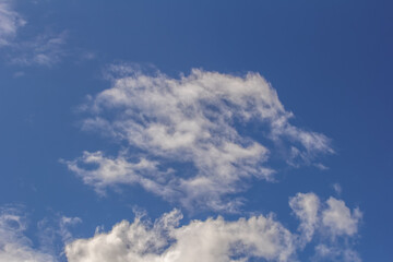 Light cumulus clouds in the blue sky