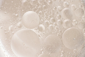 Surreal abstract beige bubbles inside liquid macro