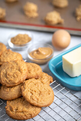 Pile of freshly baked cookies with ingredients in the background and space for text