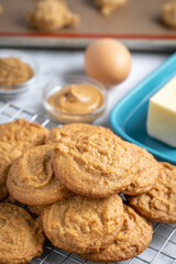 Freshly baked cookies with ingredients in the background and space for text on top
