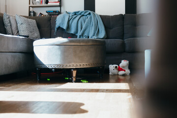 Messy authentic family room with toys on floor in home
