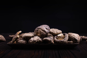 Dried shiitake mushrooms on black background 
