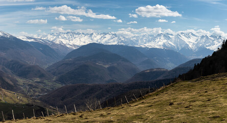 Landscape of a high mountain valley with the snow capped mountains in the background. Horizontal image