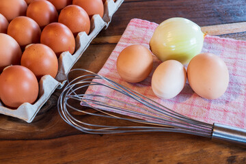 fresh brown and white chicken eggs on a plate on wooden background