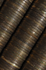 Wallpaper from stacks and edges of yellow coins placed at an angle diagonally across the shot. Ten Russian rubles. Dark vertical background on economic or financial topic. Macro