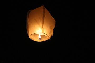 Leaving a lantern in the Sky through the darkness