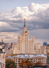 Fototapeta na wymiar Stalin's skyscraper in Moscow. High-rise on Kotelnicheskaya embankment in the panorama of the city. City landscape in cloudy weather.