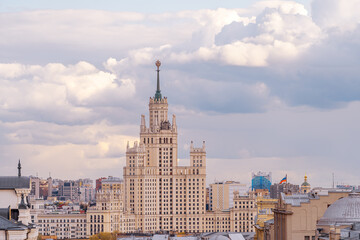 Fototapeta na wymiar Stalin's skyscraper in Moscow. High-rise on Kotelnicheskaya embankment in the panorama of the city. City landscape in cloudy weather.