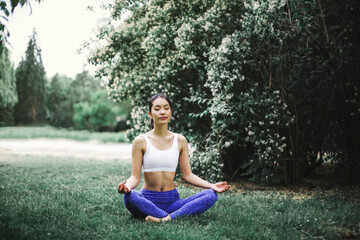 Asian girl is doing yoga in a park