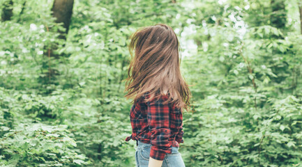 Portrait of a girl on the background of the forest,Girl's hair fly apart