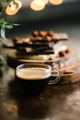 espresso and chocolate bars on a Board with nuts