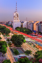 Aerial view of "9 de Julio" Avenue, with car light traces and buildings, during twilight. Buenos Aires, Argentina