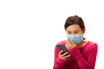 Young asian woman reading message on cell phone and wearing mask
