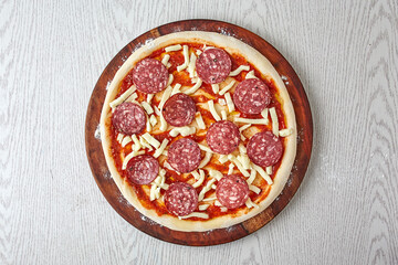 Pizza ingredients, pizza dough with tomato sauce and mozzarella cheese on wooden board isolated on gray background. (How to make Pizza?) The basics of pizza making process, top view