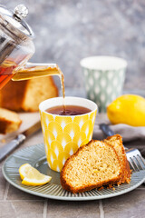 Lemon cake slices and cup of hot black tea