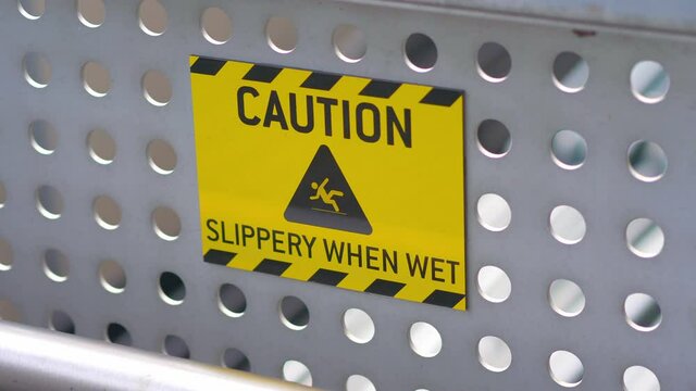 Caution Slippery Floor Surface Sign in 4K Slow motion 60fps