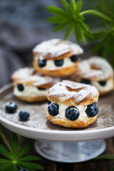 Cream puff rings (choux pastry) decorated with fresh blueberries
