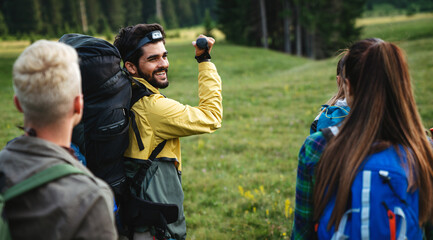 Group of happy fit friends hiking, trekking together outdoor nature