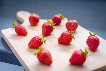 Fresh ripe delicious strawberries on wooden board.