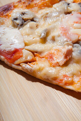 Slice of delicious pizza on the cutting board