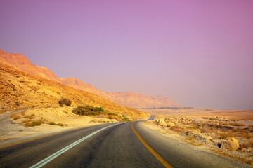 Fototapeta na wymiar Driving a car on mountain Israel road. Desert landscape. Journey by car. View from the car of a mountain landscape in the morning. Israel