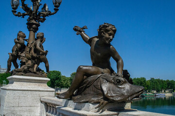 beautiful decorative statues on the bridge of Alexander III in Paris