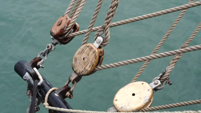 Tall Ship pully system for the mast ropes sailing on the English Channel with the sea in the background.