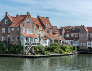 Fototapeta na wymiar classical Dutch houses at the waterside of Enkhuizen