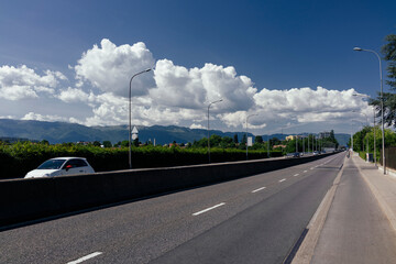 Highway on a sunny day on a background of cloudy sky.