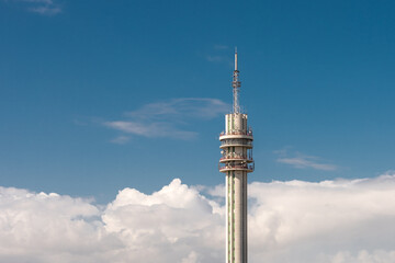 Communications tower surrounded with white clouds