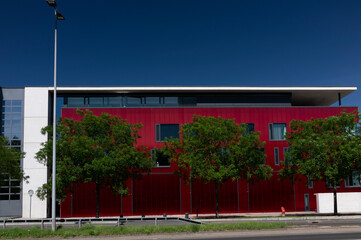 Office building with a red wall.