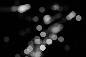 The abstract black and white bokeh of night lighting represents the beauty of the lights that adorn the buildings in the metropolis of brightness.